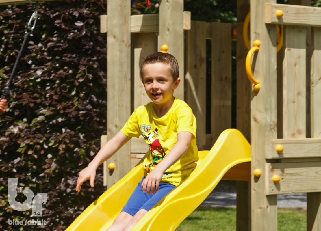 wooden blue rabbit playtower with boy on on yellow slide