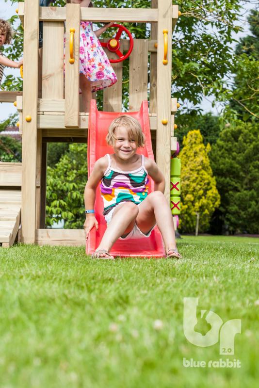 wooden Blue Rabbit playtower cascade with girl on slide smiling